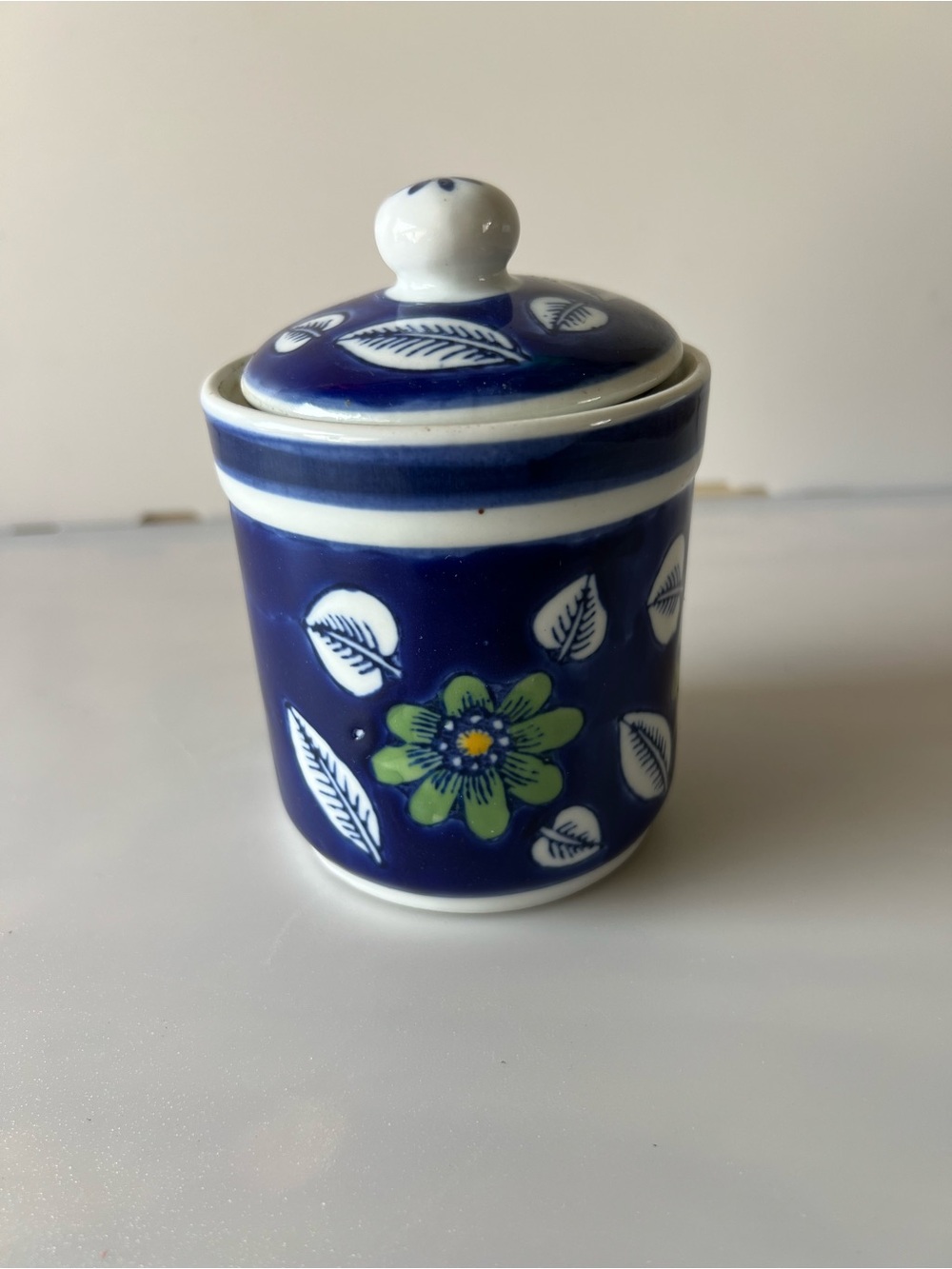 vintage Polish ceramic jar with a hand-painted Delft-style floral design